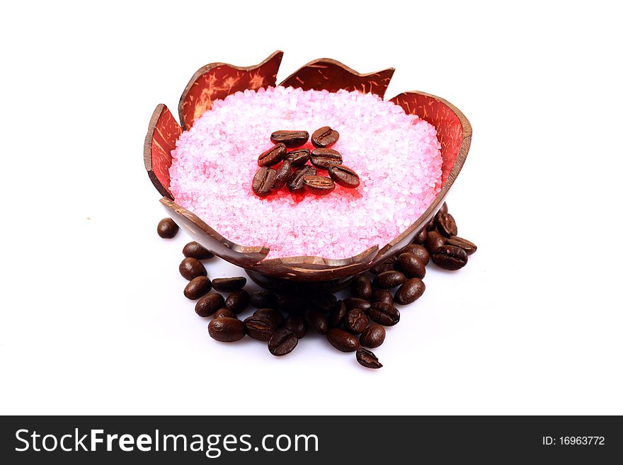 Bowl of bathing salt  and coffee beans on white isolated background.