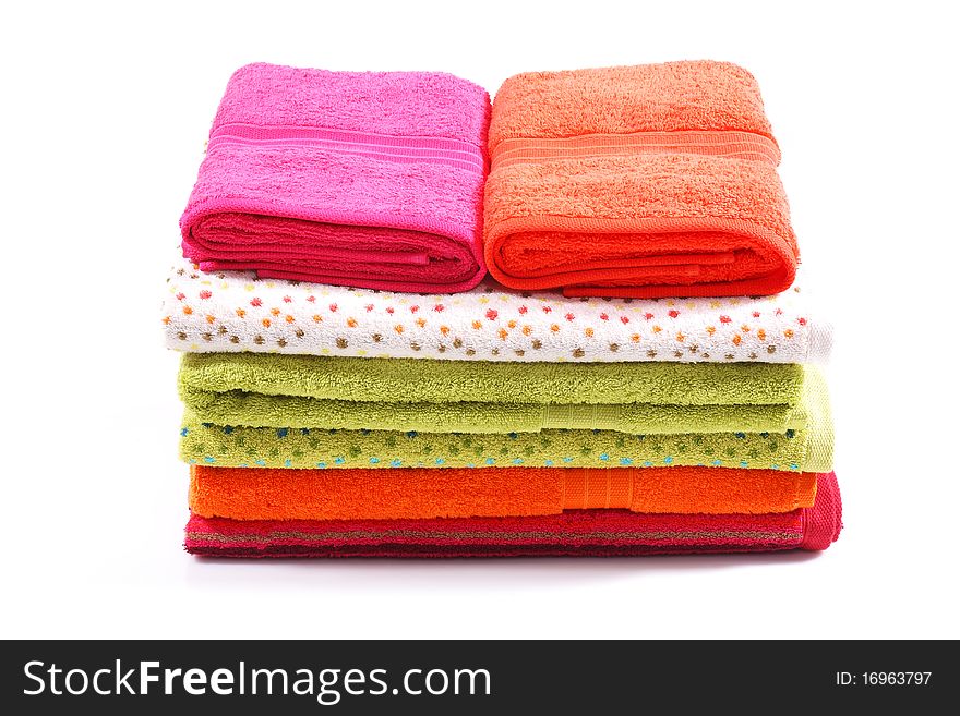 Seven different colored towels stacked one on another