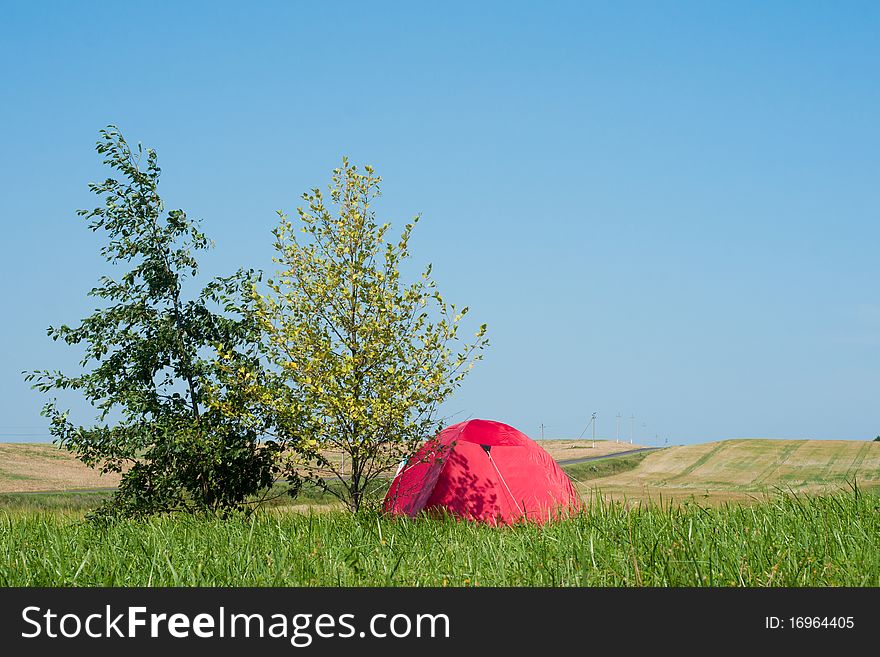 Tourist Tent In The Field With Road And Hills