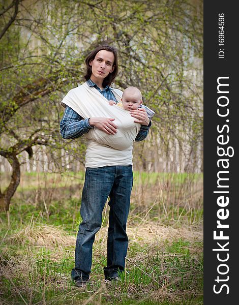 Father walking with daughter in sling.