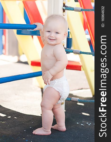 Littele baby play on playground.