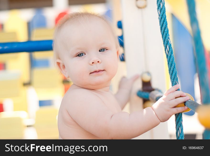 Littele baby play on playground.