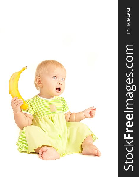 Young little baby eat yellow banana on white.
