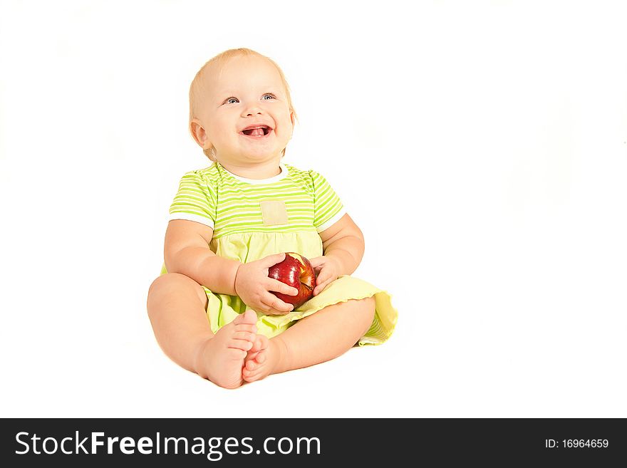 Young little baby eat red apple on white.