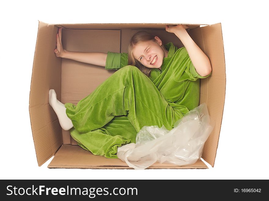 Young adorable woman sit in paper box and strech it by hands and legs