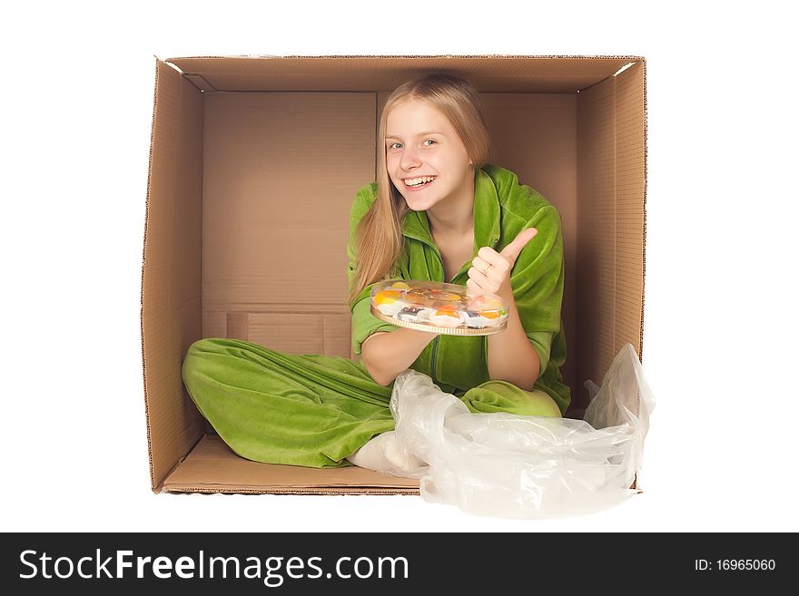 Young adorable woman sit in paper box and show plate with variety of fruits and berries. Young adorable woman sit in paper box and show plate with variety of fruits and berries