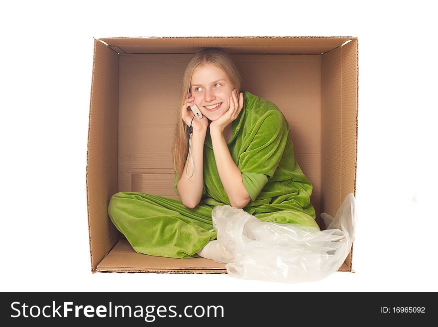 Young adorable businesswoman calling the phone sitting in box