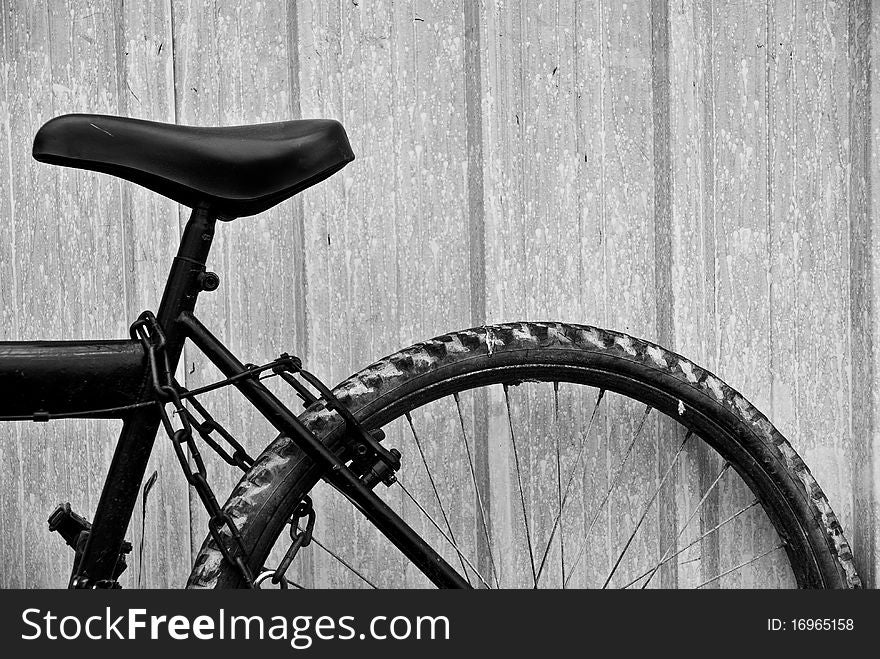 Abandoned Bicycle By A Fence