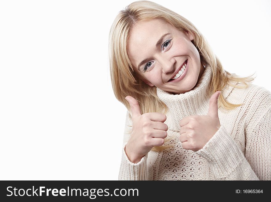 Attractive woman holds a thumbs up on a white background. Attractive woman holds a thumbs up on a white background