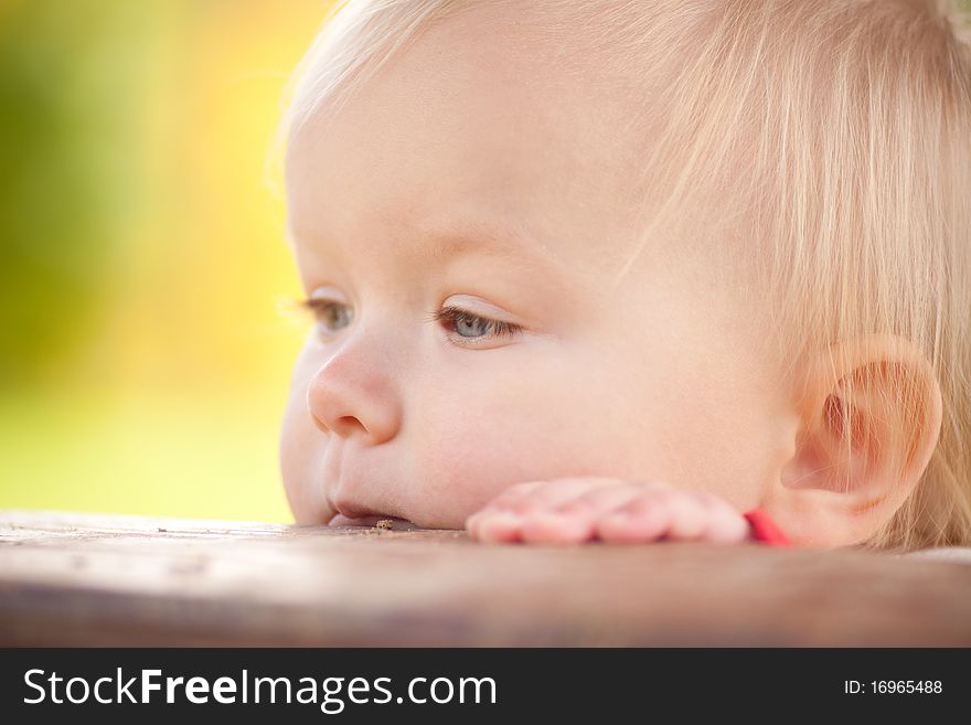 Close up of young cheerful girl look from hideout in house on playground