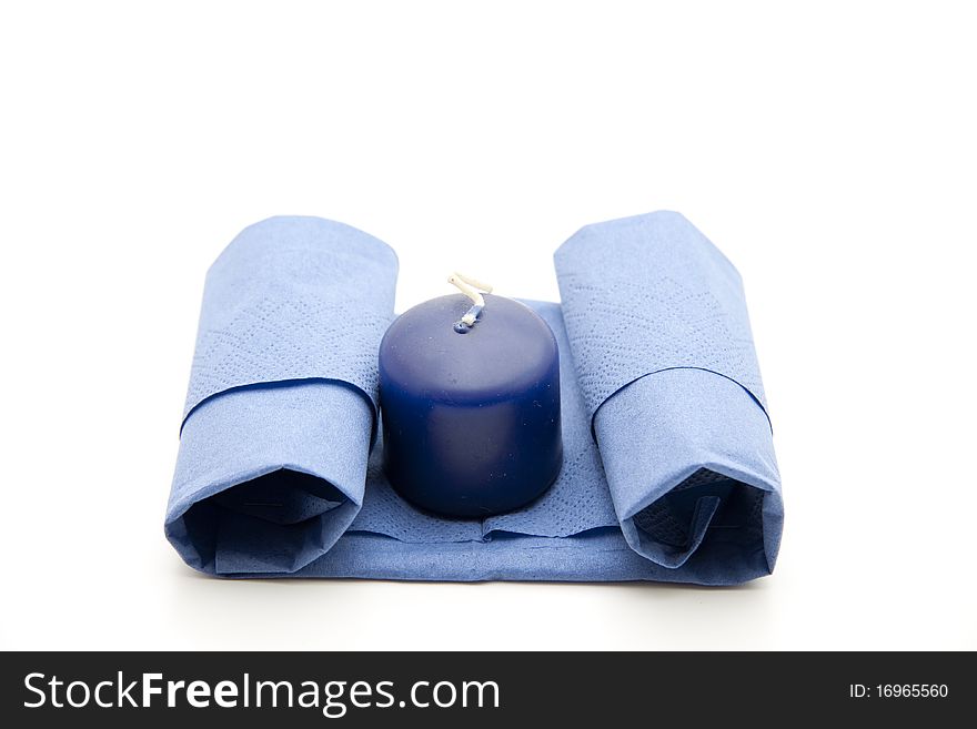 Napkin folded with blue candle