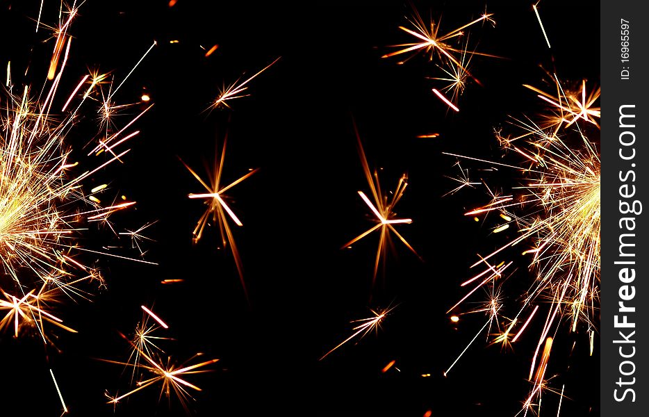 Golden sparkler on black background