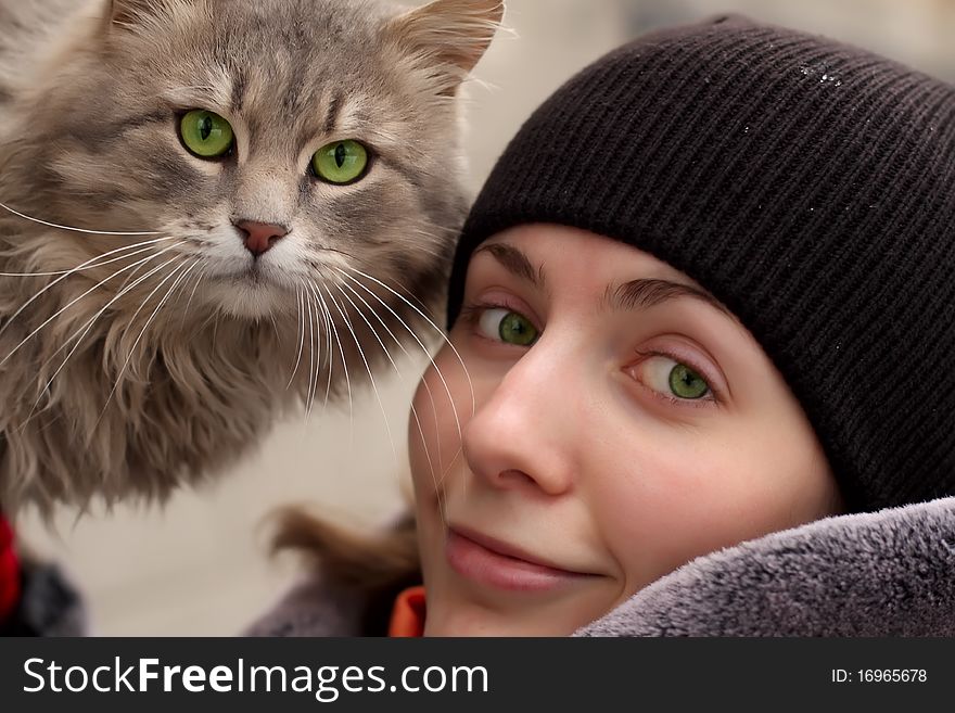 Wonderful girl and cat by a large plan