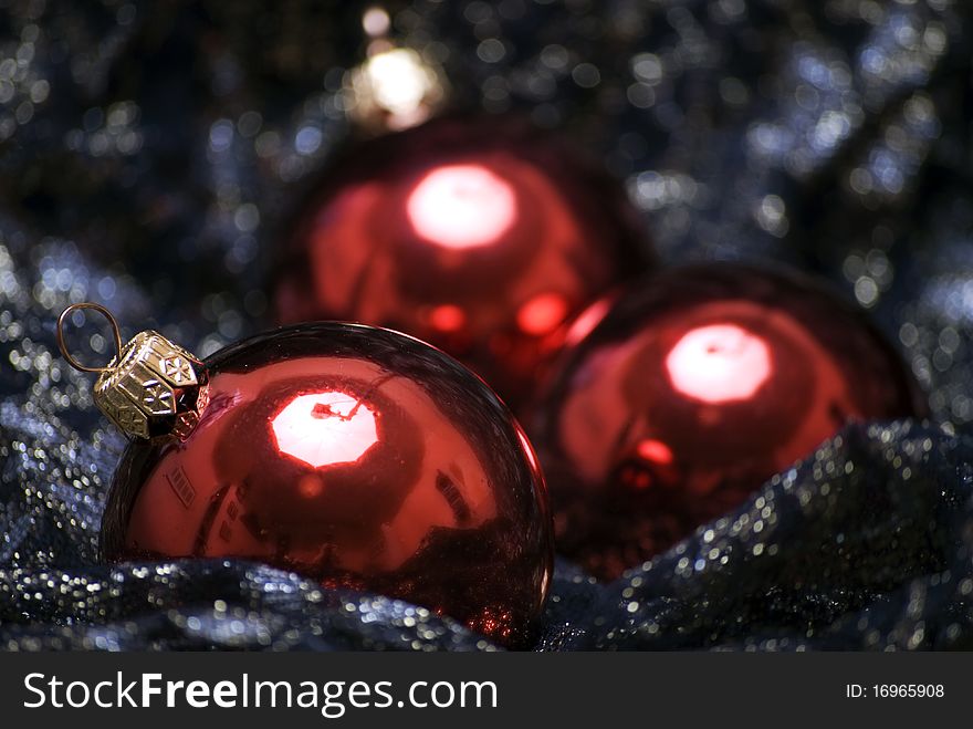 Red Christmas balls on the sheer black material. Red Christmas balls on the sheer black material