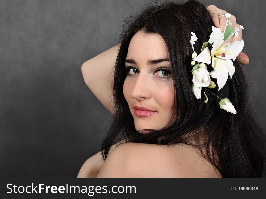 Beautiful woman with a flower in hairs