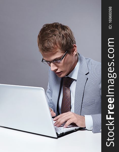 Young businessman working with laptop. Young businessman working with laptop