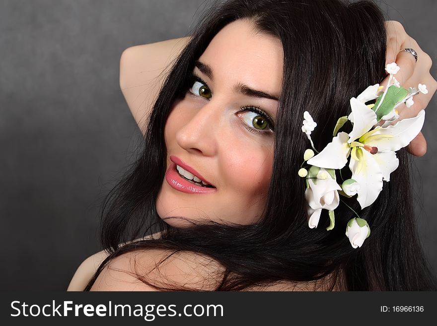 Beautiful woman with a flower in hairs