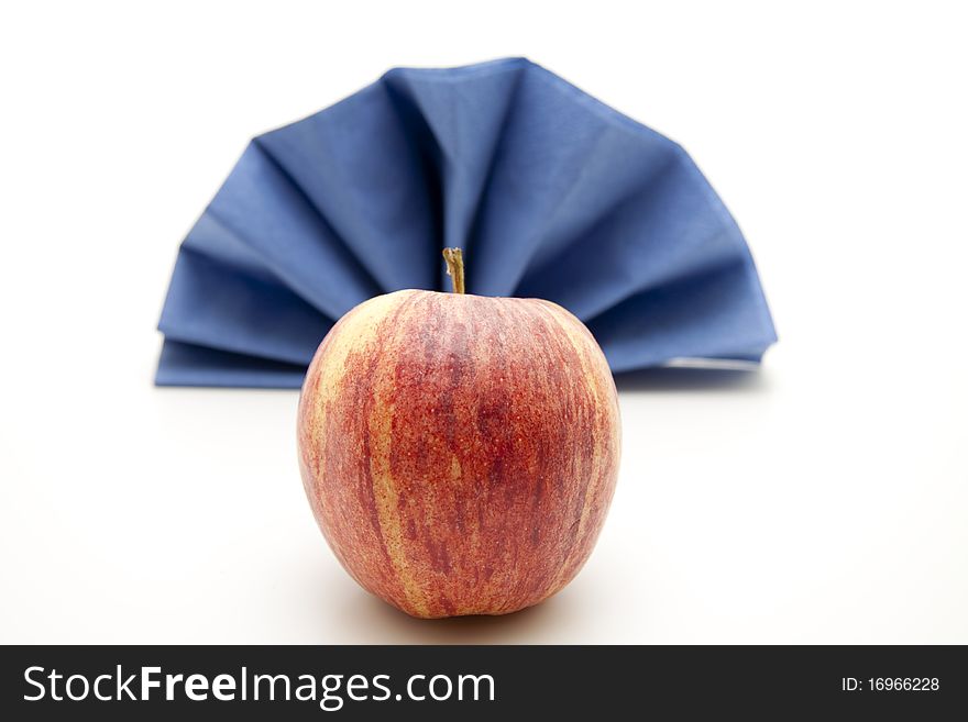 Napkin folded with red apple. Napkin folded with red apple