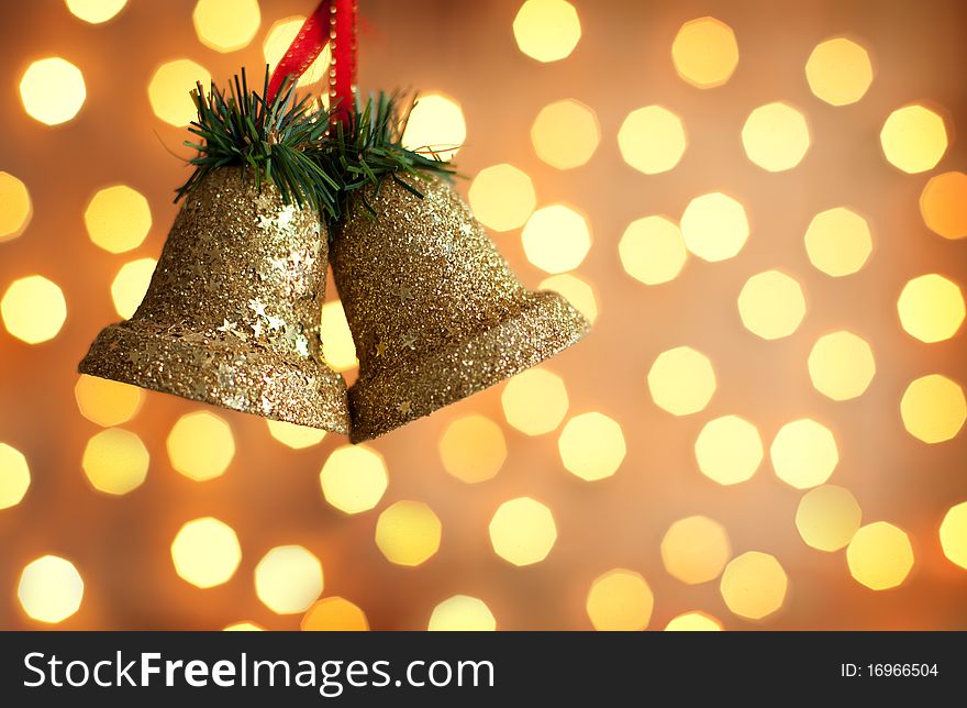 Two bells with lights in the background.