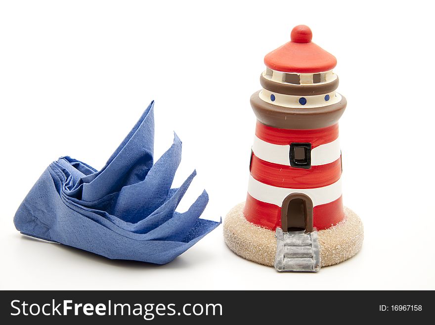 Folded napkin to the ship and with lighthouse