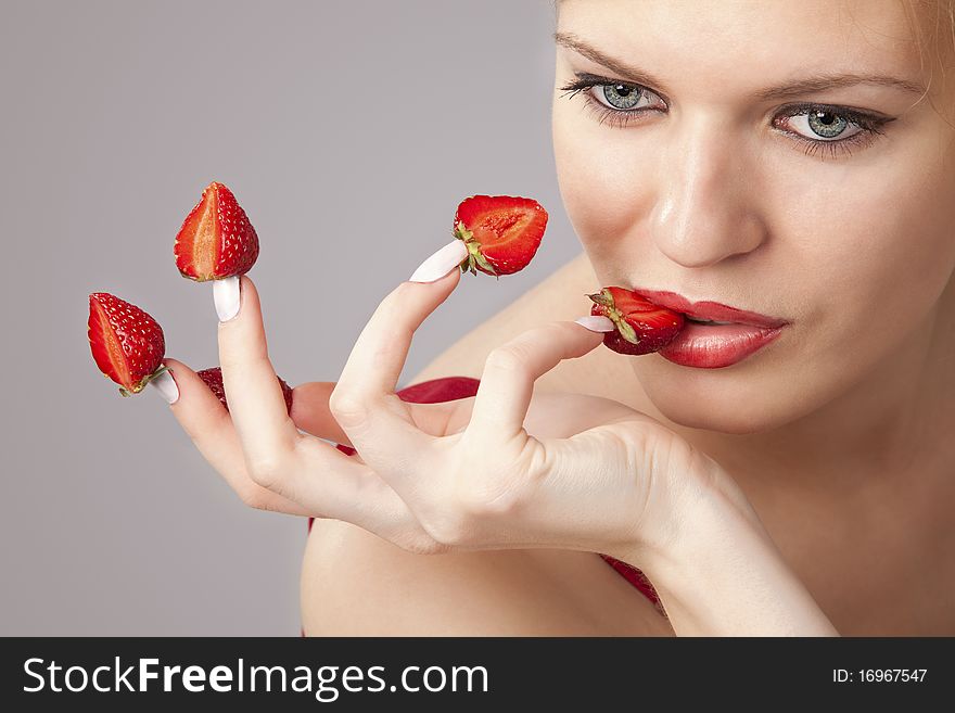 Woman With Red Strawberries Picked On Fingertips