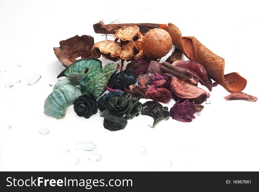 Potpourri and drops of water on a white background