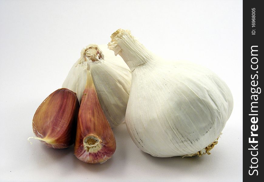 A selection of different pieces of garlic on a white background. A selection of different pieces of garlic on a white background