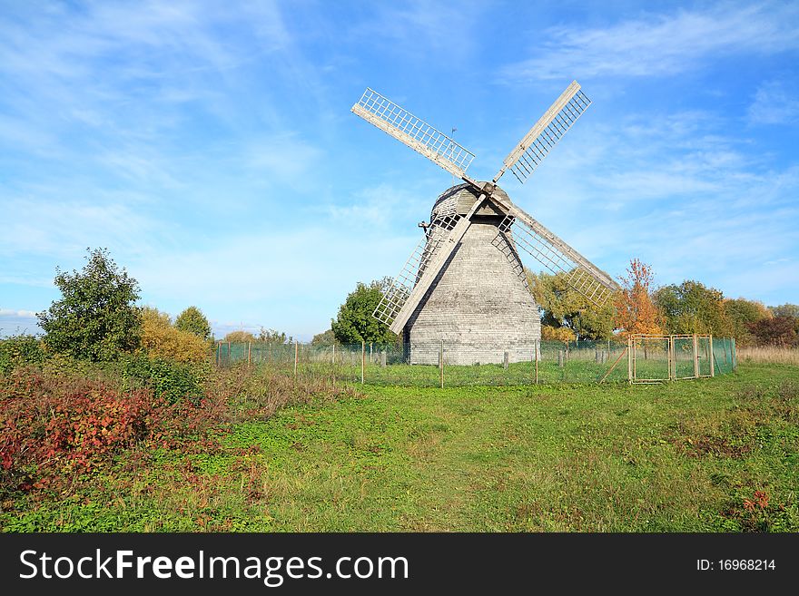 Aging wooden mill on a celestial background