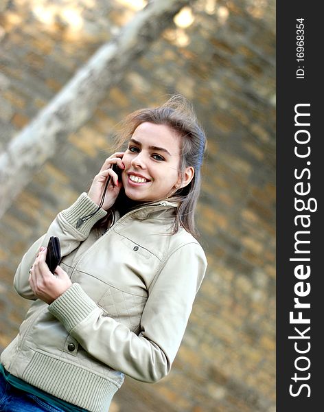 Young girl smiling while talking on cellular phone. Young girl smiling while talking on cellular phone