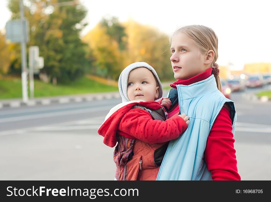 Mother with baby stay on crossroad.