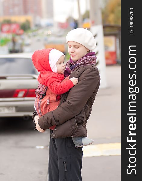 Young adorable mother and toddler girl stay on crossroad