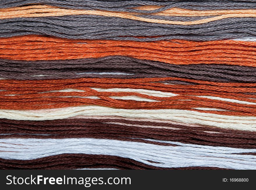 Close-up of multicolored embroidery threads backgrounds, horizontal