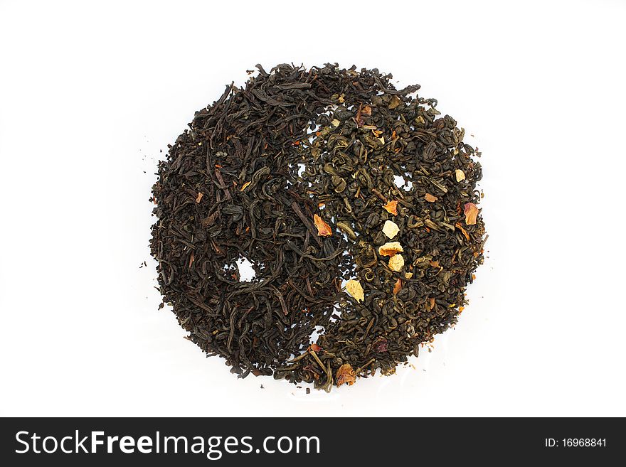 Sprinkle of green and black tea on a white background in the shape of the yin-yang