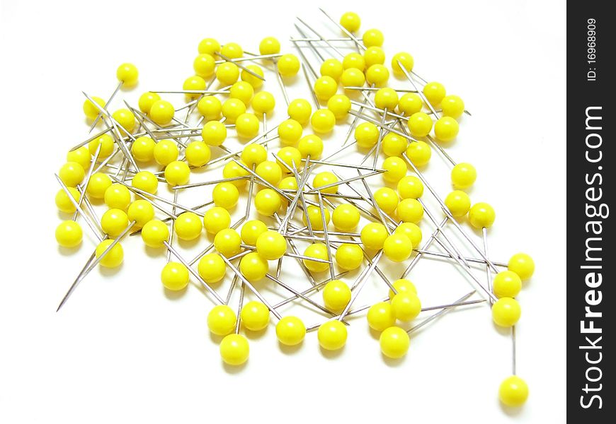 Pins on a white background with yellow heads. Pins on a white background with yellow heads.