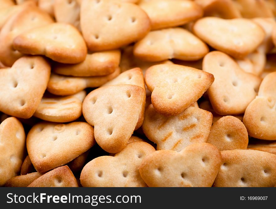 Background of salted heart shaped crackers. Background of salted heart shaped crackers