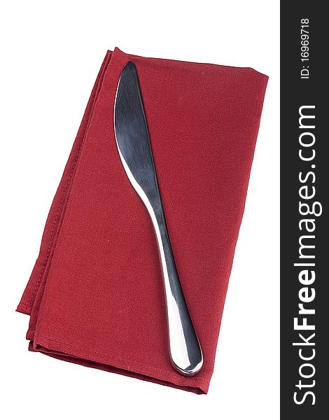 Table knife on a red cloth, tissue.