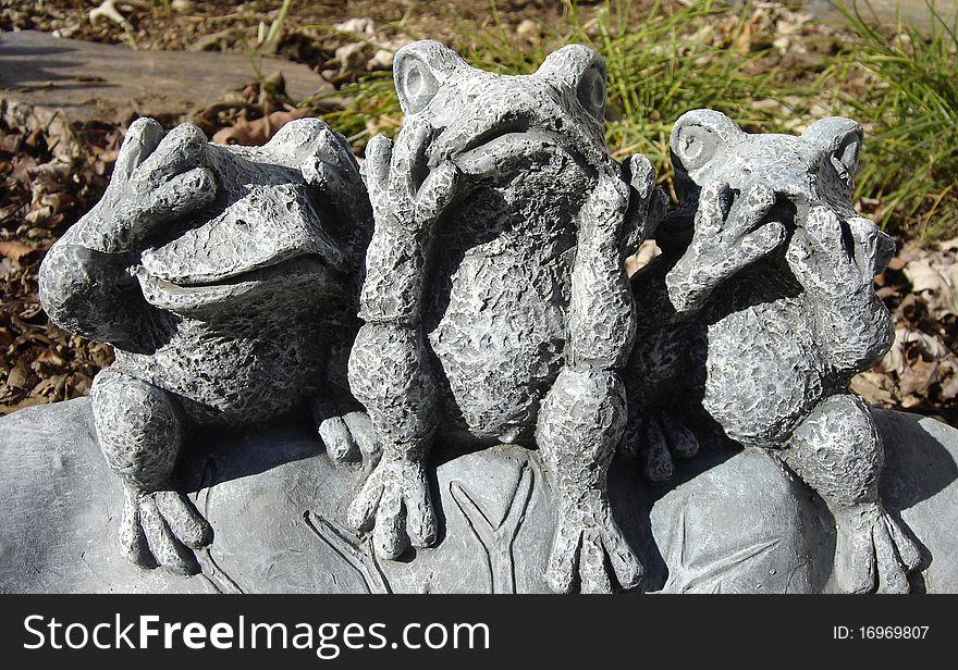 Whimsical garden frogs displaying classic aphorism. Whimsical garden frogs displaying classic aphorism