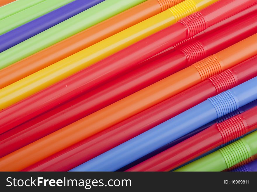 Plastic tubes of different colors in the background.