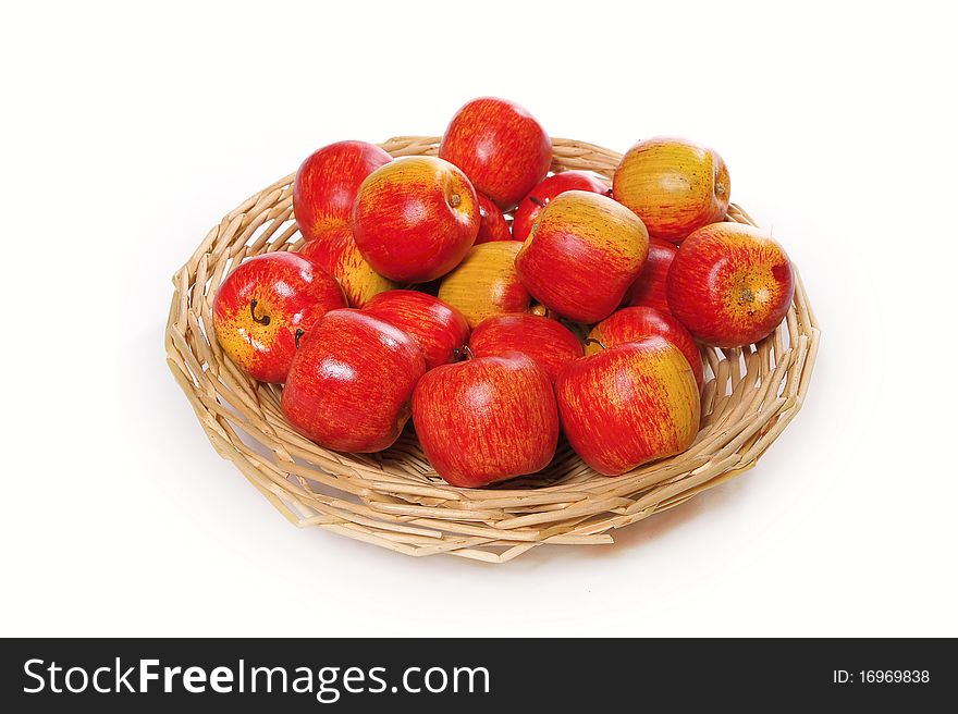 Apples on handbasket isolated on a white background