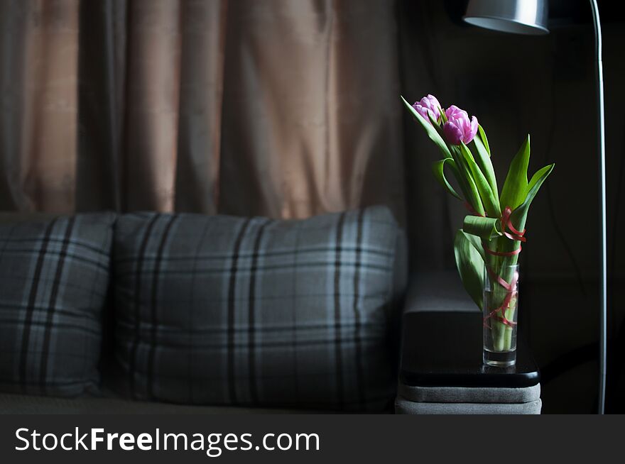 Flowers tulips in the vase in minimalism interior flat