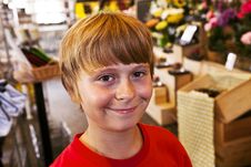 Young Boy Smiles In A Shop Royalty Free Stock Photography