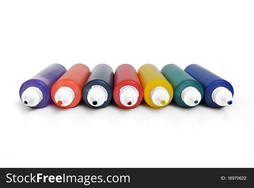 Group of seven multicolored color tubes on white background. Group of seven multicolored color tubes on white background