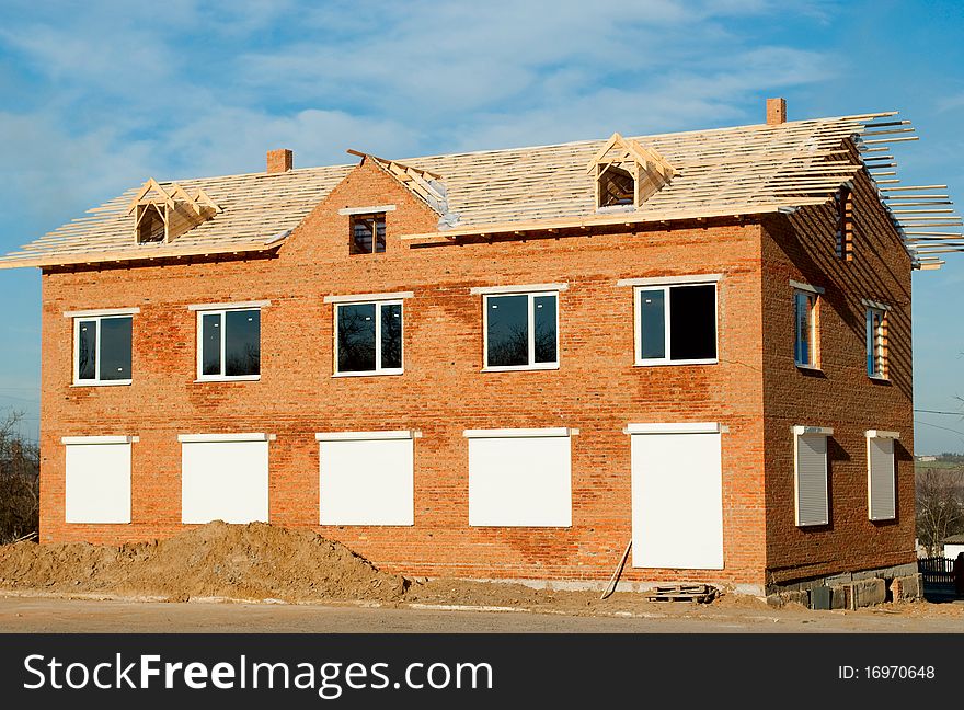 Construction of buildings of brick against the blue sky. Construction of buildings of brick against the blue sky