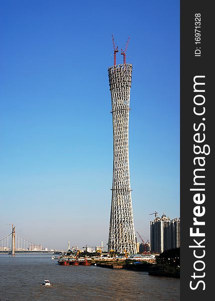 Canton tower under construction with blue sky in guangzhou city.