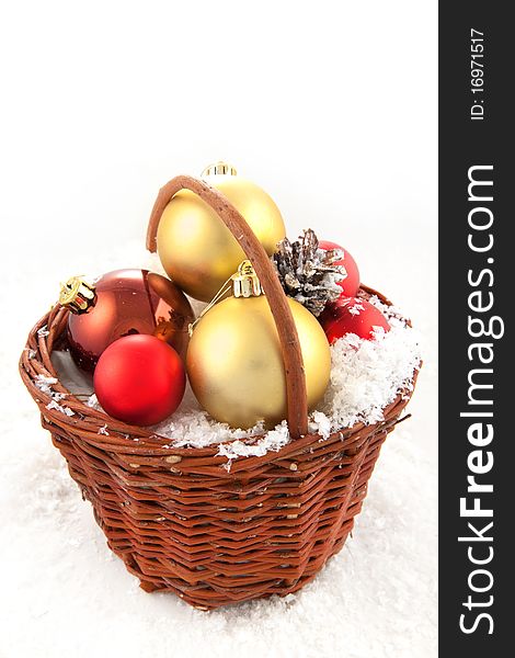 Colorful christmas toys in the basket on the snow