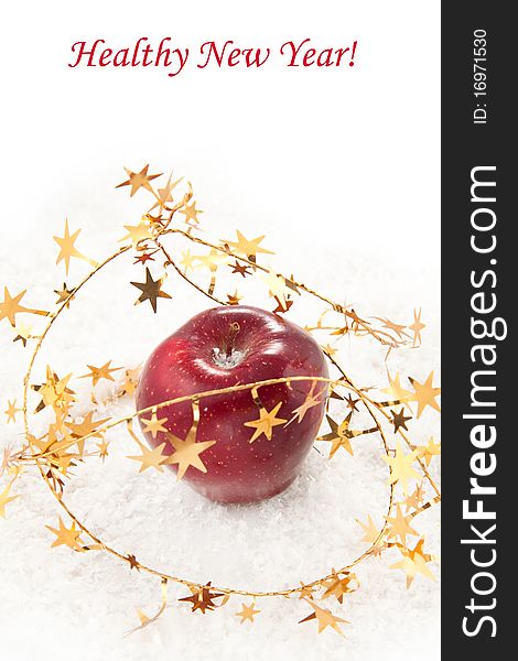 Fresh red apple with christmas stars on the white snow