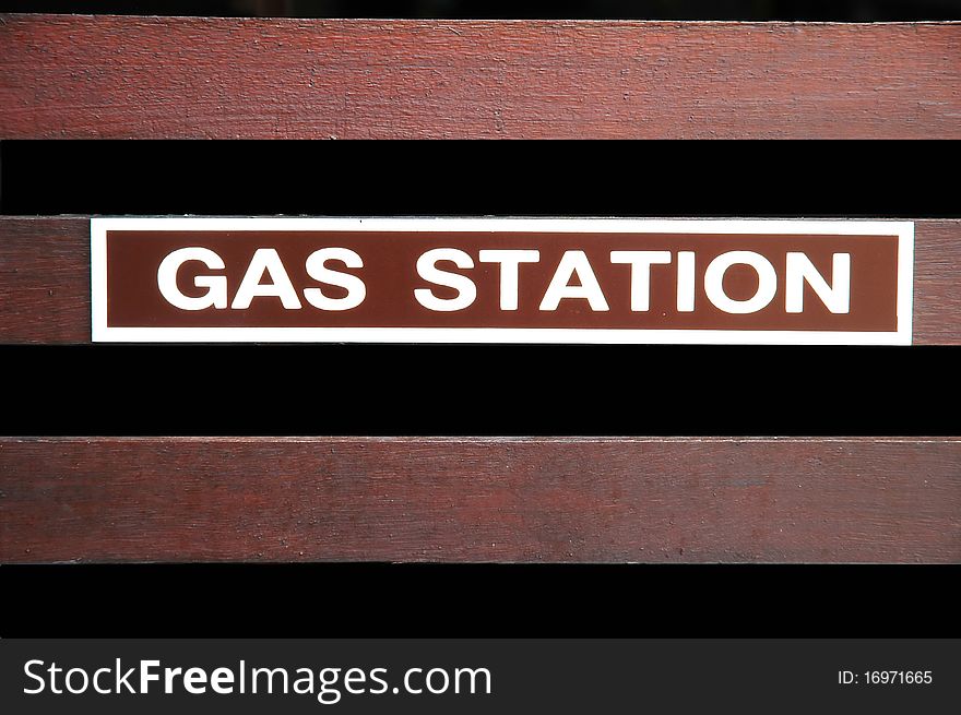 Gas station text sign on wood