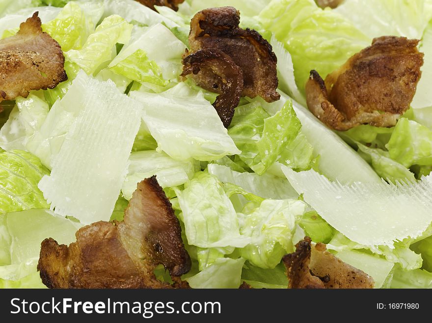 Macro shot of a fresh caesar salad with big bacon piece and parmesan. Large depth of field. Macro shot of a fresh caesar salad with big bacon piece and parmesan. Large depth of field.