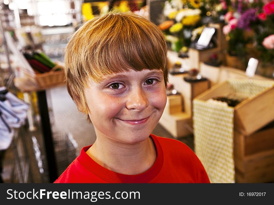 Happy young boy smiles in a shop