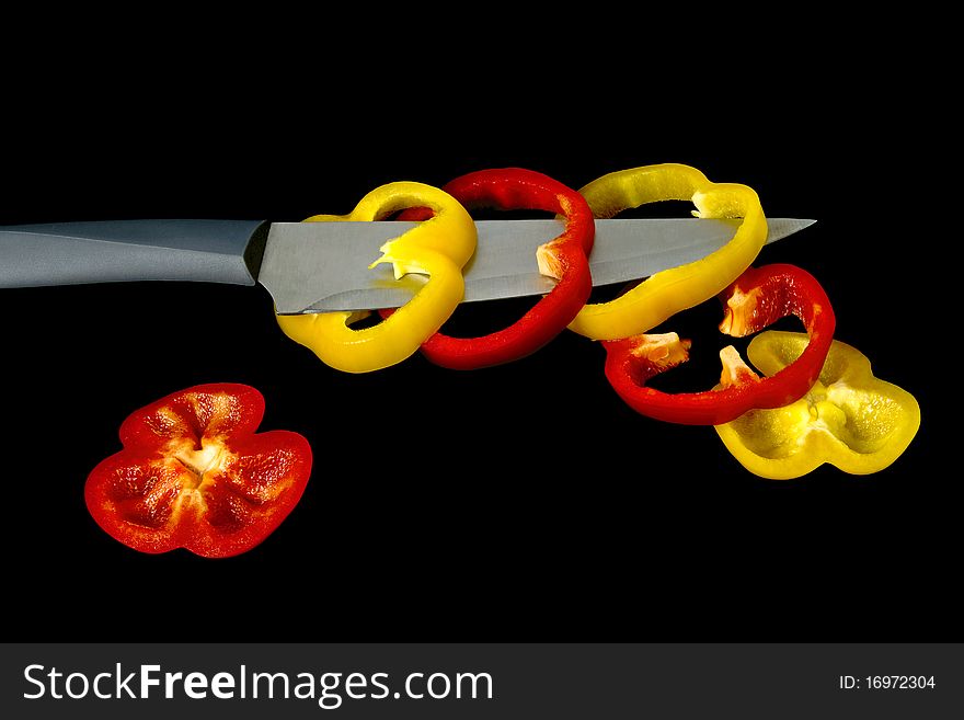 A Pepper Is Cut With A Knife